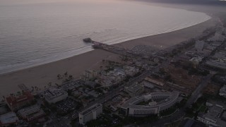 AX69_040 - 4.8K aerial stock footage approach Santa Monica Pier and the beach at twilight, California