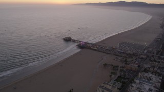 AX69_041 - 4.8K aerial stock footage fly over the beach and by the end of Santa Monica Pier at twilight, California