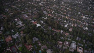 AX69_051 - 4.8K aerial stock footage of flying over mansions and upscale houses at twilight in Brentwood, California
