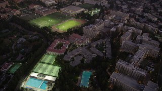 AX69_056 - 4.8K aerial stock footage orbit of campus buildings and sports fields at twilight at College, Westwood, California