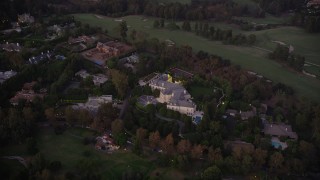 AX69_061 - 4.8K aerial stock footage of spacious Holmby Hills mansion at twilight in Los Angeles, California