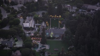AX69_063 - 4.8K aerial stock footage orbit of The Playboy Mansion at twilight in Los Angeles, California