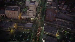 AX69_073 - 4.8K aerial stock footage fly over office buildings on Wilshire Boulevard through Mid-Wilshire area of Los Angeles, California at twilight