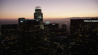 AX69_088 - 4.8K aerial stock footage approach tops of high-rises in Downtown Los Angeles at twilight, California