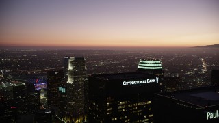 AX69_090 - 4.8K aerial stock footage fly over Downtown Los Angeles skyscrapers to approach 777 Tower at twilight, California