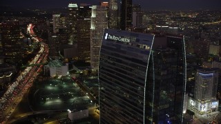 AX69_094 - 4.8K stock footage aerial video flyby the Ritz-Carlton Hotel to reveal skyscrapers in Downtown Los Angeles at night