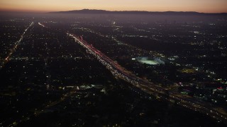 AX69_096 - 4.8K aerial stock footage of heavy traffic on I-10 past Pico-Union area of Los Angeles, California at twilight