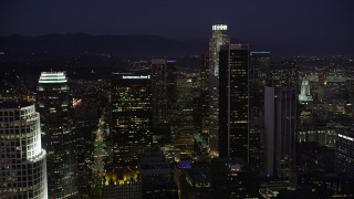 AX69_099 - 4.8K aerial stock footage approach the tall skyscrapers of Downtown Los Angeles, California at night