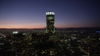 AX69_112 - 4.8K aerial stock footage orbit of US Bank Tower in Downtown Los Angeles at night, California