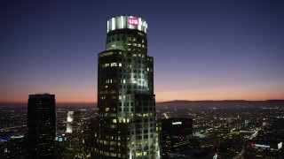 AX69_113 - 4.8K aerial stock footage of an orbit of US Bank Tower in Downtown Los Angeles at nighttime, California