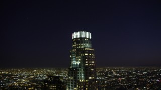AX69_114 - 4.8K aerial stock footage orbit around US Bank Tower in Downtown Los Angeles, California at night