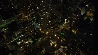 AX69_115 - 4.8K aerial stock footage of Los Angeles Public Library and 5th Street in Downtown Los Angeles at night, California