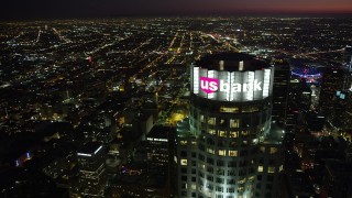 AX69_118 - 4.8K aerial stock footage orbit of the top of US Bank Tower in Downtown Los Angeles at night, California