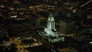 AX69_120 - 4.8K aerial stock footage of Los Angeles City Hall and courthouse in Downtown Los Angeles, California at nighttime