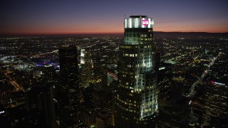 AX69_123 - 4.8K aerial stock footage flyby US Bank Tower and tops of Downtown Los Angeles, California skyscrapers at night
