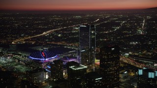 AX69_124 - 4.8K stock footage aerial video approach Staples Center, Nokia Theater, The Ritz-Carlton Hotel in Downtown Los Angeles, California at night