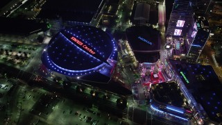 AX69_127 - 4.8K stock footage aerial video reverse view of Staples Center, Nokia Center, and Ritz-Carlton in Downtown Los Angeles at night, California