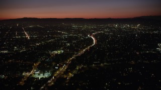 AX69_134 - 4.8K aerial stock footage of heavy traffic on Highway 101 and East Hollywood neighborhoods at night, California