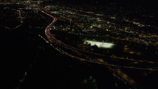 AX69_139 - 4.8K aerial stock footage of heavy traffic on the I-5 and Highway 134 Interchange in Glendale at night, California