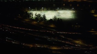 AX69_140 - 4.8K aerial stock footage of rush hour traffic on I-5 and Highway 134 interchange in Glendale at night, California