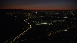 AX69_141 - 4.8K aerial stock footage of heavy rush hour traffic on Highway 134 by Burbank at night, California
