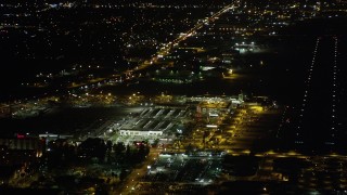 AX69_146 - 4.8K aerial stock footage strip mall by terminals at Bob Hope International Airport at night, Burbank, California