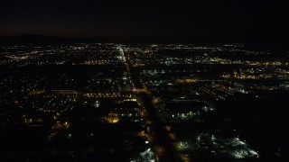 AX69_151 - 4.8K aerial stock footage of warehouse buildings on San Fernando Road at night in Pacoima, California