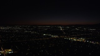 AX69_156 - 4.8K aerial stock footage of Interstate 5 and residential neighborhoods at night in Arleta, California