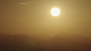 AX70_002 - 4K aerial stock footage View of the sunrise over the mountains