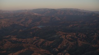 AX70_006 - 4K aerial stock footage Approach a lake in the Los Padres National Forest at sunrise, California