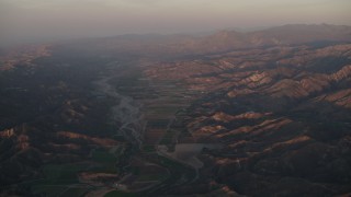 AX70_007 - 4K aerial stock footage Farm fields by the Santa Clara River at sunrise, Piru, California