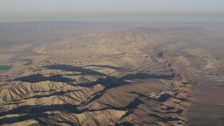 AX70_031 - 4K aerial stock footage Flyby mountain ridges at sunrise, Cuyama, California