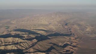 AX70_032 - 4K aerial stock footage Rugged mountain ridges at sunrise, Cuyama, California