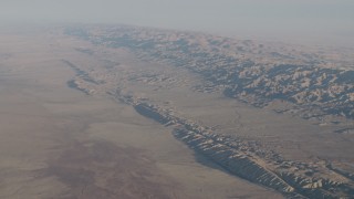 AX70_038 - 4K aerial stock footage of The San Andreas Fault in a desert plain by the Temblor Range in Southern California