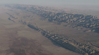 AX70_040 - 4K aerial stock footage Approach San Andreas Fault in a desert plain beside the Temblor Range in Southern California