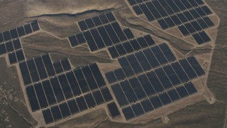 AX70_056 - 4K aerial stock footage Tilt to a bird's eye of solar panels at the Topaz Solar Farm in the Carrizo Plain, California