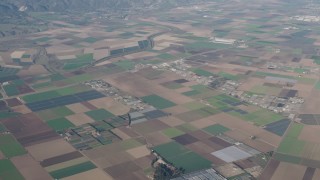 AX70_082 - 4K aerial stock footage of A view of farms, greenhouses, and crop fields in Salinas, California