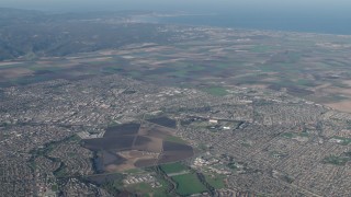 AX70_086 - 4K aerial stock footage of A view of farm fields around suburban neighborhoods in Salinas, California