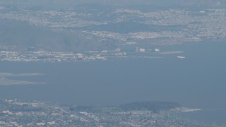 AX70_096 - 4K aerial stock footage Commercial airliner flying near San Francisco International Airport in California
