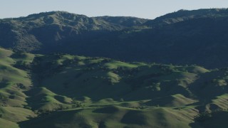 AX70_100 - 4K stock footage aerial video Green hills and mountains in springtime, Gilroy, California