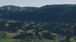 AX70_101 - 4K stock footage aerial video Flyby green hills and mountains in springtime, Gilroy, California