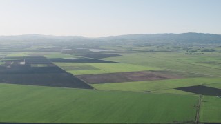 AX70_105 - 4K stock footage aerial video Flying over large crop fields in Hollister, California