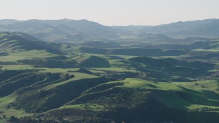 AX70_114 - 4K aerial stock footage Approaching green hills in Hollister, California