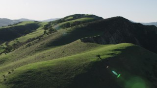 AX70_121 - 4K aerial stock footage Flying over green hilltops in Hollister, California