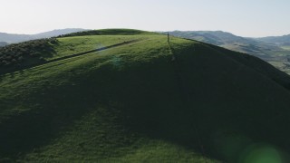 AX70_130 - 4K aerial stock footage Fly over hilltops in Hollister, California
