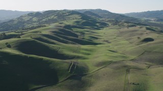 AX70_138 - 4K aerial stock footage Fly over green hills in Paicines, California