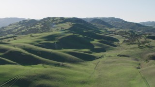 AX70_140 - 4K aerial stock footage Green hills and trees in Paicines, California