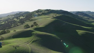 AX70_142 - 4K aerial stock footage Fly over hilltops and trees in Paicines, California