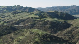 AX70_152 - 4K aerial stock footage Approach hills with trees in Paicines, California