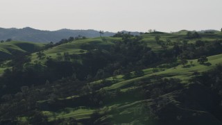 AX70_153 - 4K aerial stock footage Tree covered hillsides in Paicines, California